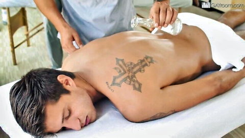 Tattooed Latino hunk gets oiled back massage from male therapist