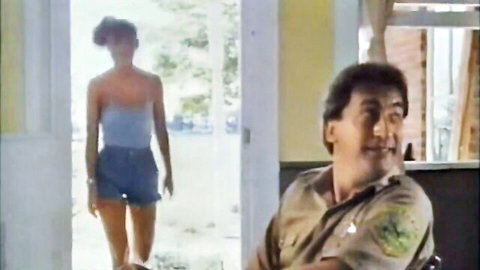 Bonnie Beck in blue tube top and denim shorts at door with man in uniform
