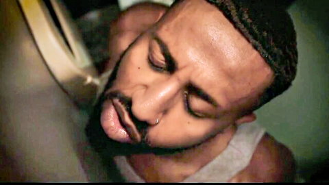 Bearded black man eyes closed tongue out in ecstasy sucking cock at gloryhole