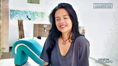 Smiling curvy Latina Carla Mercado teasing deep cleavage in tight V-neck top
