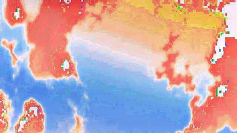 Satellite infrared image of island landmass with red orange heat zones in blue ocean