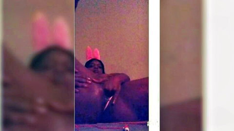 Curvy Black woman in bunny ears masturbating solo on bed