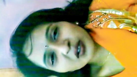 Seductive Desi Indian woman in orange saree with bindi and earrings