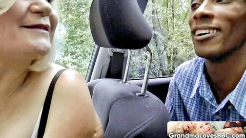 Granny smiles flirtatiously at BBC driver in car on road trip