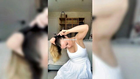 Blonde beauty in white dress brushing her long hair solo
