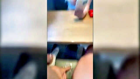 Blurry amateur upskirt under desk showing spread thighs and dark pussy shadow