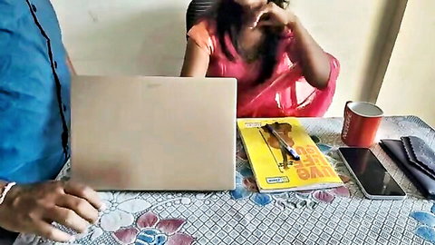 Indian madam in red saree smokes with office colleague at desk
