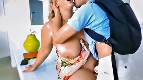 Busty blonde cougar passionately kisses young stud in floral dress