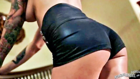 Tattooed punk girl with red hair, topless in tight black shorts showing big ass