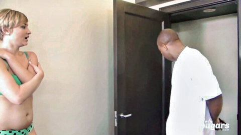 Shocked blonde in green bikini covers tits watching bald black man bend over in closet