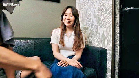 Smiling Asian amateur in white polo and blue skirt reacts playfully to touch