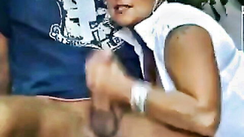 Ebony woman in white top gives footjob to man's erect cock
