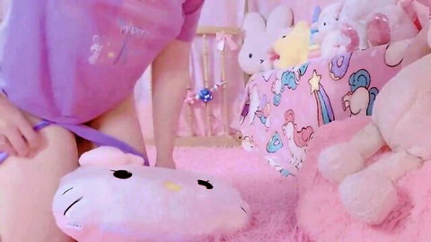 Littlekiwi in sheer pink onesie, DDLG nursery tease with Hello Kitty pillow