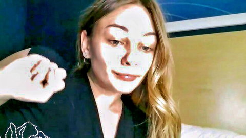 Blonde with big tits teases cleavage in open robe on webcam striptease