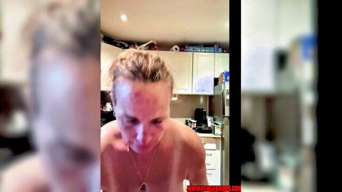 Thick blonde GILF exposing mature curves topless in kitchen