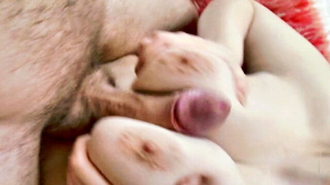 Closeup of pale babe sucking pink cockhead amid hairy pubes and soft tits