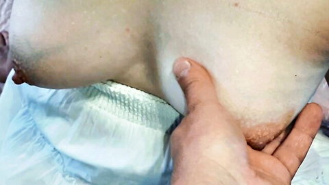 Close-up of 45yo Asian MILF's exposed breast fondled by hand
