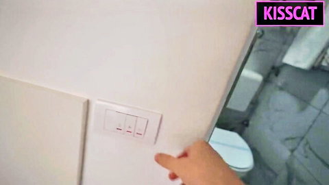 MILF stepmom hand on bathroom light switch in hotel room tease