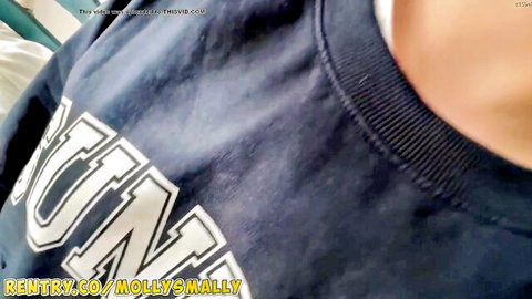 Woman in navy university hoodie with deep cleavage tease