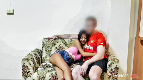 Thai beauty in pink top and shorts cuddling intimately with man