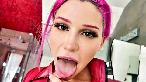 Pink-haired babe sticks out wet tongue teasing blowjob in red leather jacket POV