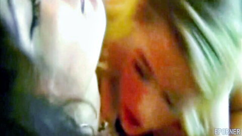 Blonde and brunette lesbians in close intimate kiss
