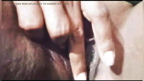 Pale fingers deeply inserted into dark skinned tight asshole closeup