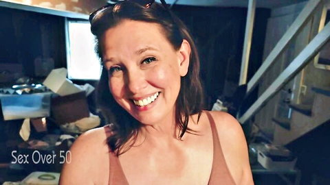 Smiling mature MILF over 50 in tight tank top teases in homemade basement
