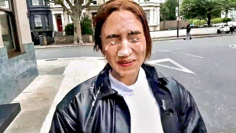 Brunette with cum-covered face in public street bukkake scene