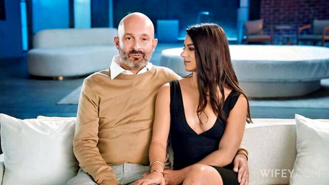 Misty Addams as young wife cuddling with hubby on couch