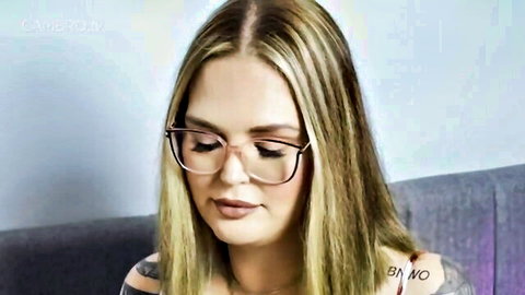 Blonde babe in glasses with BNWO tattoo teases deep cleavage in low-cut top
