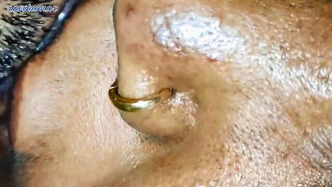 Close-up of hot Indian aunty's face with gold nose ring, mature desi beauty