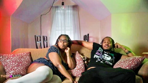 Ebony curvy couple lounging on couch in stockings during freaky podcast