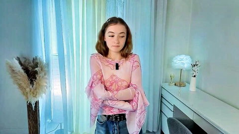Brookmazur shy young camgirl in sheer pink top, arms crossed