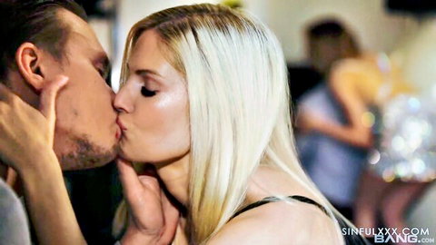 Blonde babe passionately French kissing handsome guy in steamy nightclub