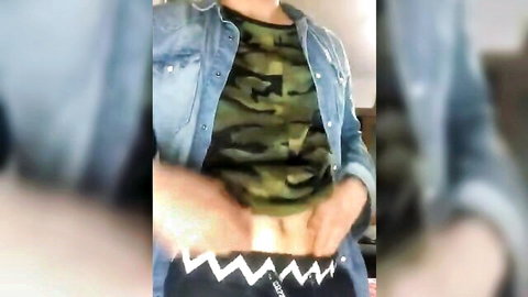 Muscular East Asian hunk in camo shirt and denim jacket pulls down pants teasing crotch and pubes