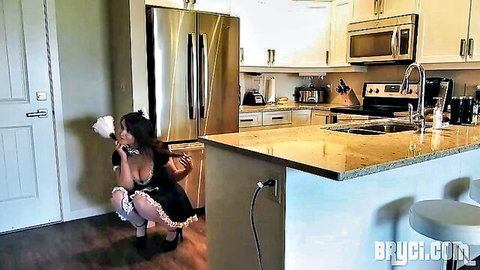 Big-titted Asian maid in frilly outfit squatting seductively in kitchen