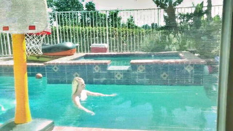 Blonde babe skinny dipping in turquoise backyard pool showing petite wet body