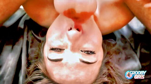 Upside-down blonde trans with massive tits and glossy red lips on bed