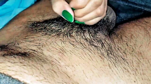 Closeup of woman's hand with green nails grabbing hairy Indian man's cock