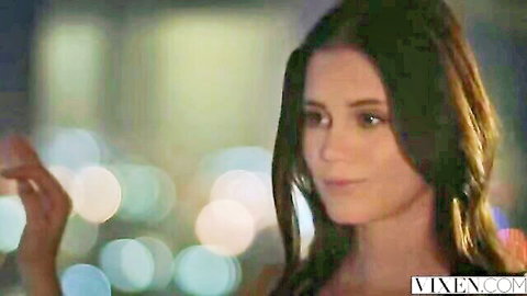 Seductive brunette stunner in elegant dress tempts viewer with sultry gaze
