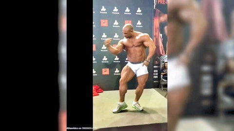 Hot muscular stud posing and stripping in white briefs on stage