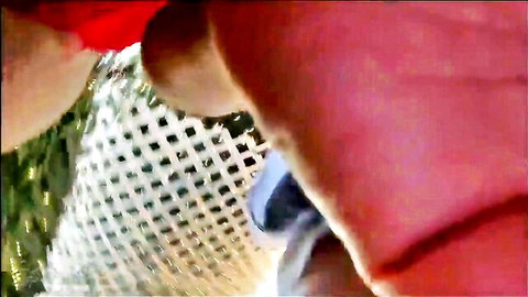 Hard erect nipple protruding through sheer fishnet lingerie on big juicy tit closeup