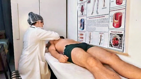 Nurse examining patient's bulge in steamy medical checkup