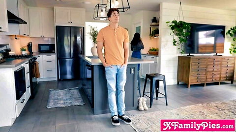 Handsome son in orange shirt eyes brunette MILF mom cooking in modern kitchen taboo tease