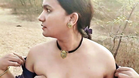Hot Indian babe in jungle pulls down purple top exposing bare shoulders and tits