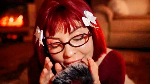 Redhead babe with glasses and bows teases fuzzy mic with lips in ASMR foreplay