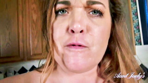 Mature brunette MILF Aunt Judy stares seductively with plump lips parted in kitchen POV