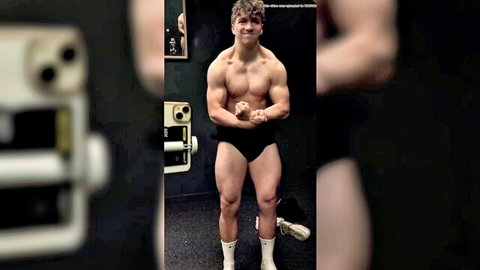 Muscular teen bodybuilder posing shirtless in gym briefs
