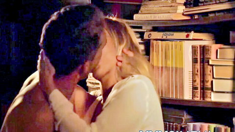 Blonde babe passionately kissing shirtless muscular guy against bookshelf